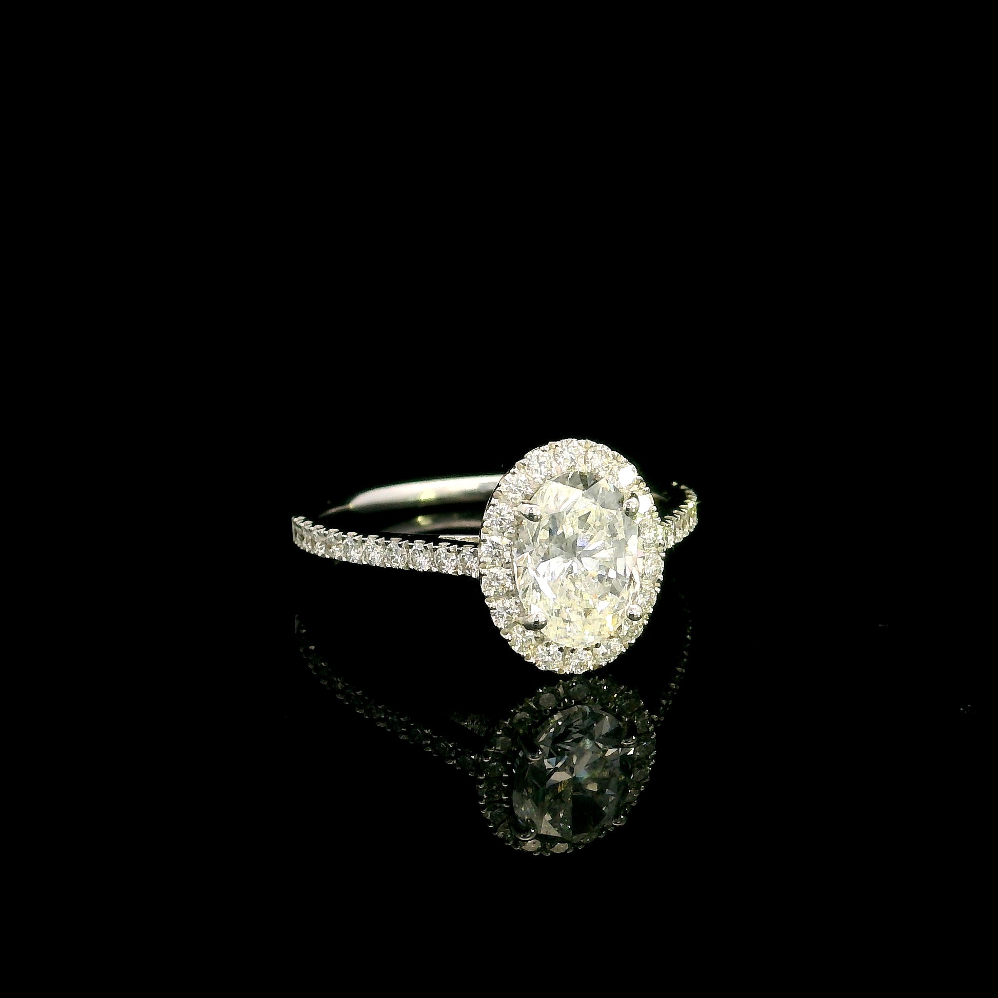 Oval diamond bridal set in 18K white gold with GIA certified natural diamond halo engagement ring and matching diamond wedding band