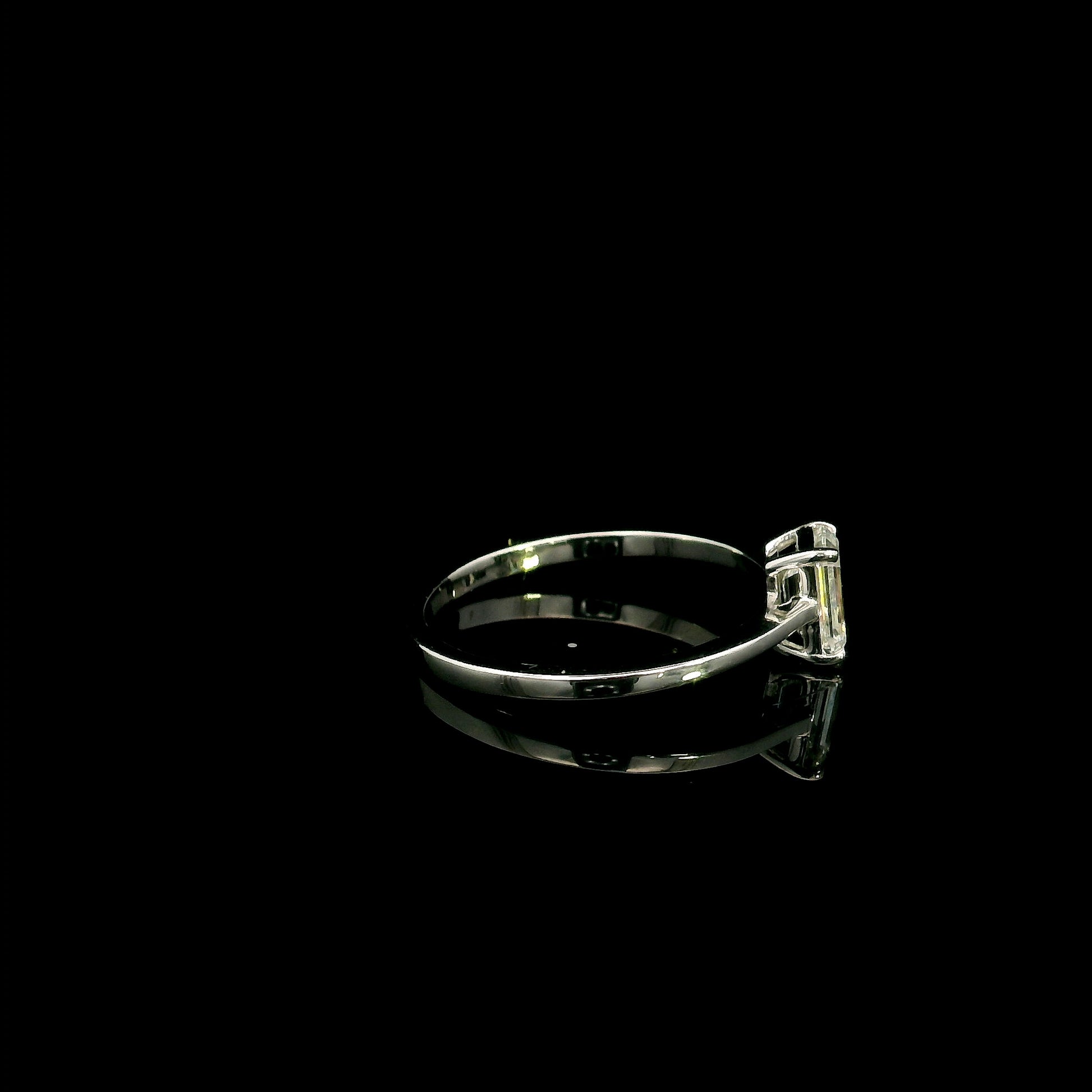 18K white gold solitaire ring featuring a 0.90 carat IGI certified natural emerald cut diamond with VS2 clarity and D colour in a classic four-prong setting.