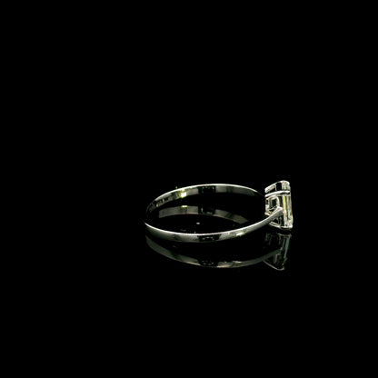 18K white gold solitaire ring featuring a 0.90 carat IGI certified natural emerald cut diamond with VS2 clarity and D colour in a classic four-prong setting.