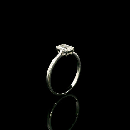 18K white gold solitaire ring featuring a 0.90 carat IGI certified natural emerald cut diamond with VS2 clarity and D colour in a classic four-prong setting.