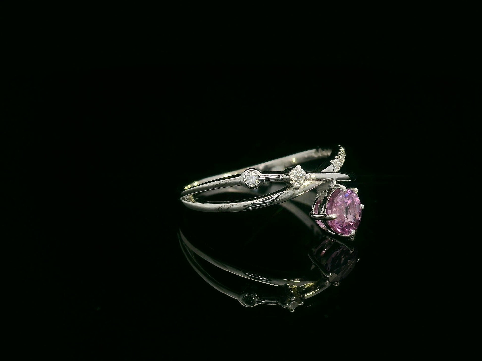 18K white gold bypass ring with 0.76ct round pink sapphire and 0.19ct diamond accents – Emirates Diamonds