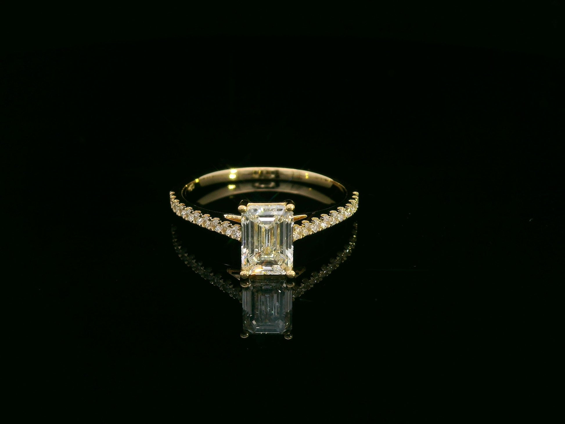 Emerald-cut diamond engagement ring and pavé wedding band bridal set in 18K yellow gold – Emirates Diamonds.