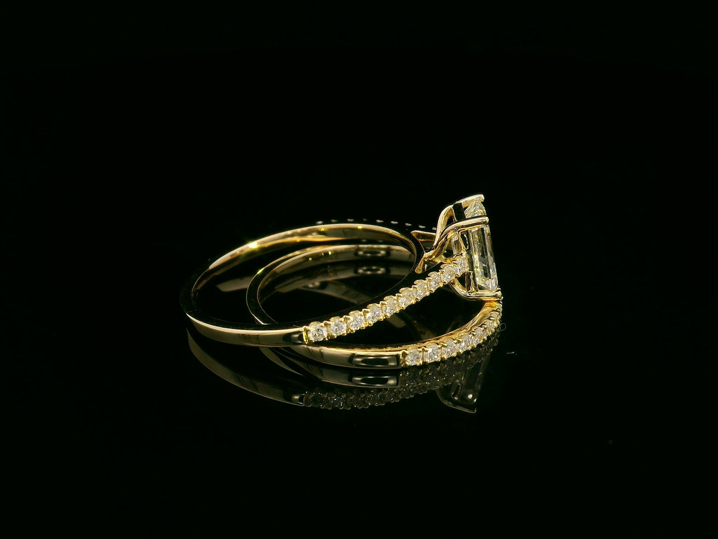 Emerald-cut diamond engagement ring and pavé wedding band bridal set in 18K yellow gold – Emirates Diamonds.