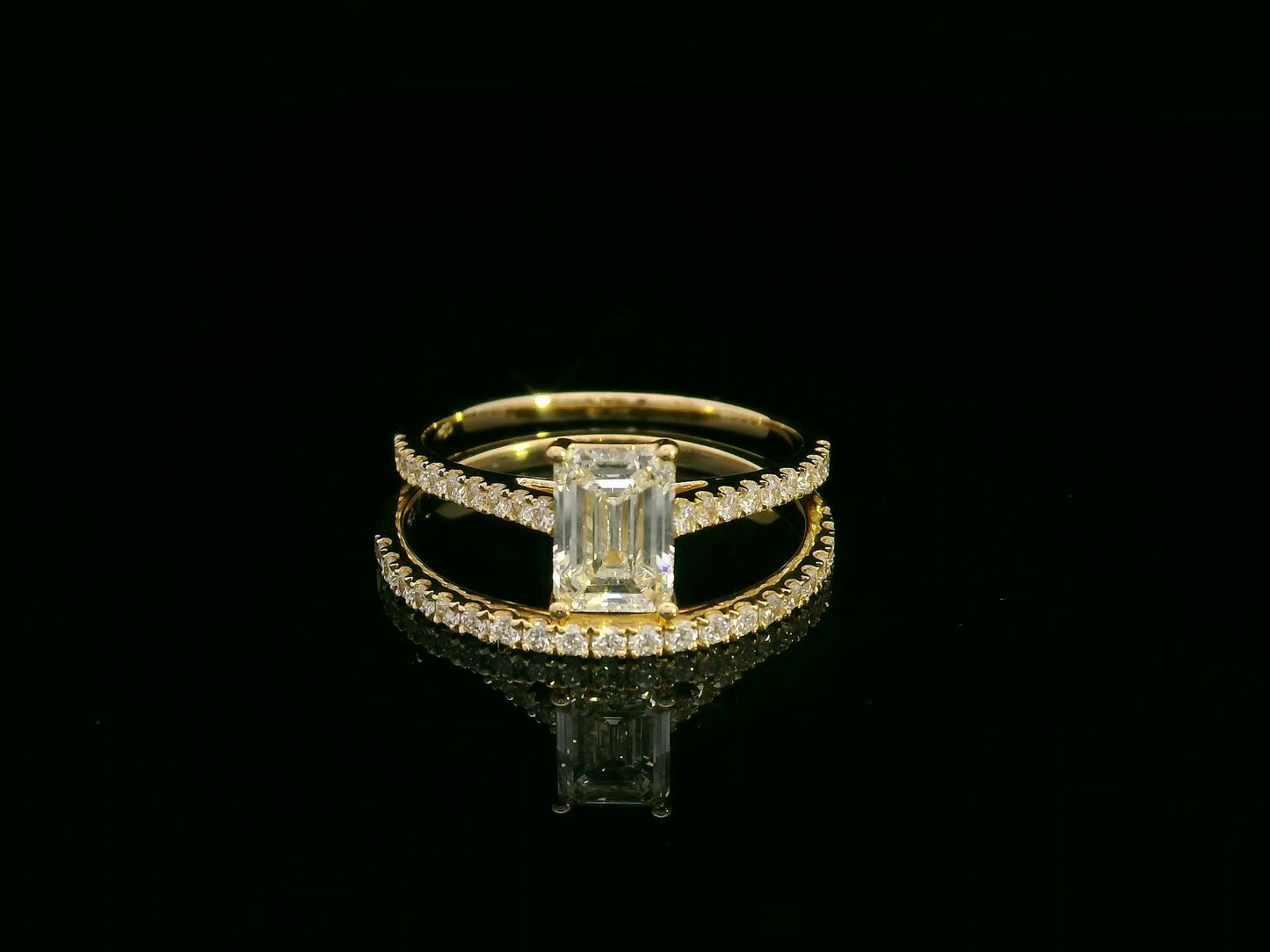 Emerald-cut diamond engagement ring and pavé wedding band bridal set in 18K yellow gold – Emirates Diamonds.