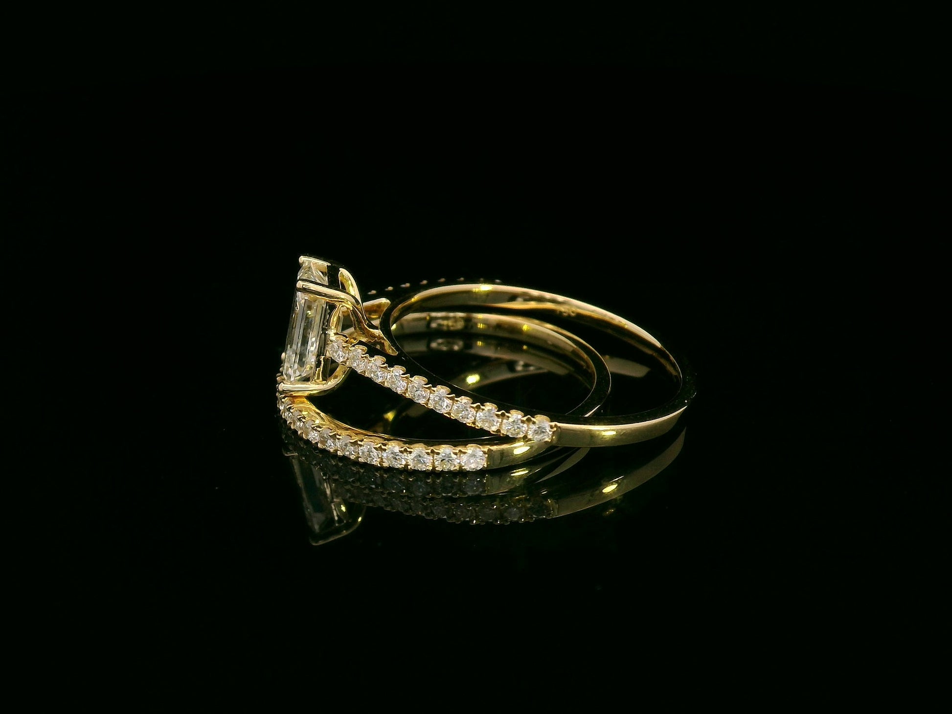 Emerald-cut diamond engagement ring and pavé wedding band bridal set in 18K yellow gold – Emirates Diamonds.