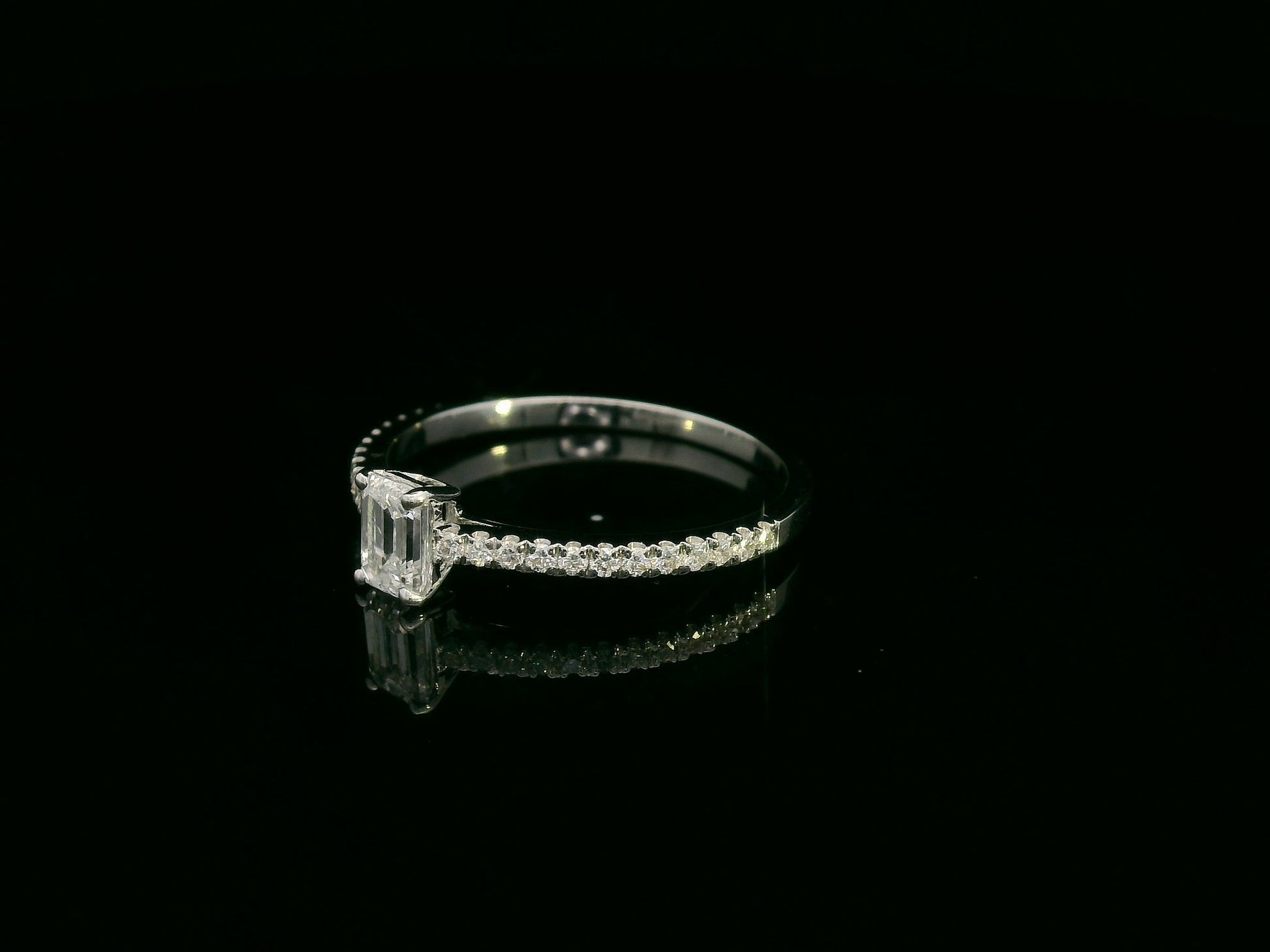 Emerald-cut diamond ring in 18K white gold with pavé band – 0.40ct D/VS1 GIA center stone by Emirates Diamonds.