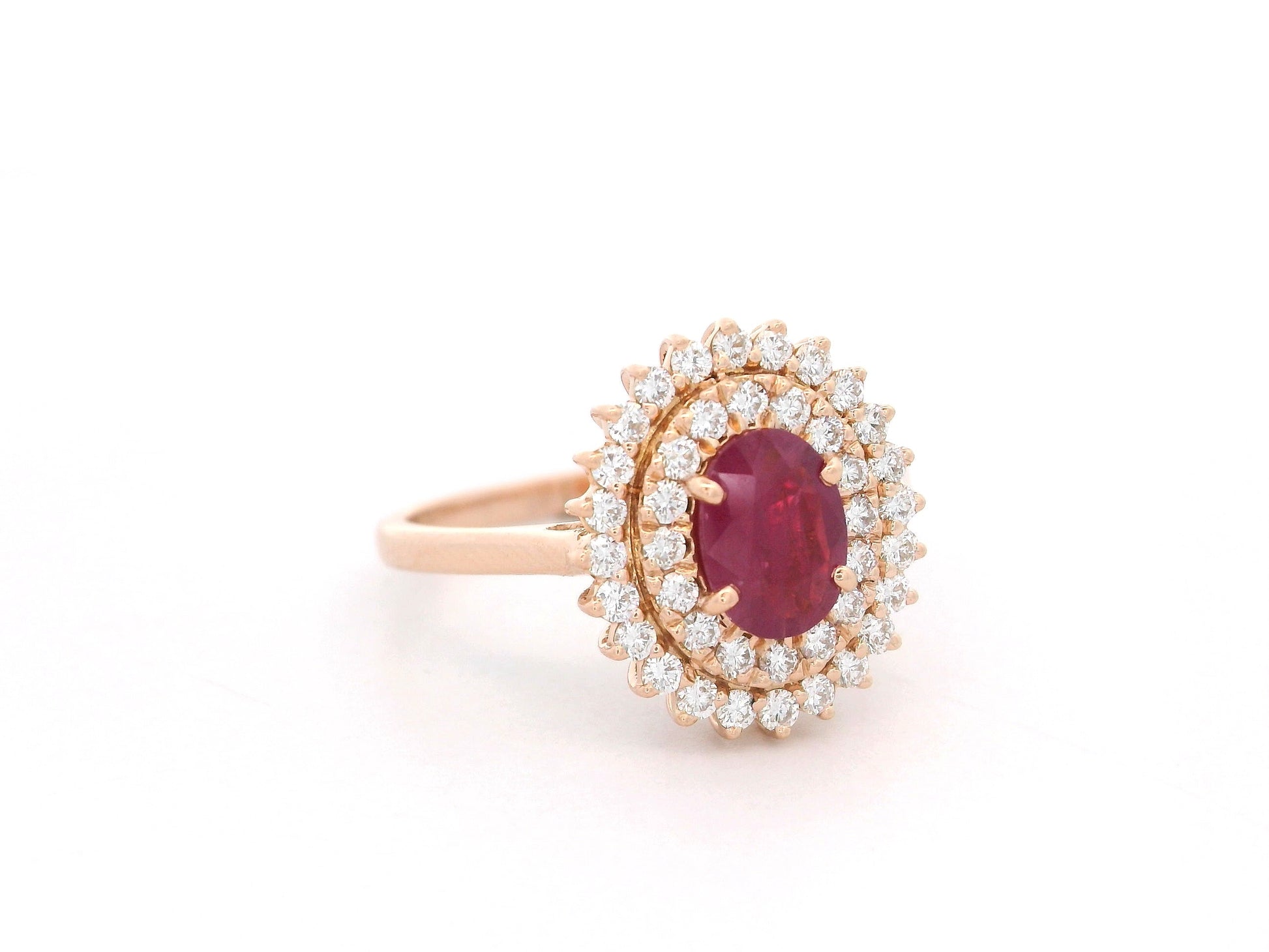 18K rose gold ruby and diamond double-halo ring – 0.80ct oval ruby with 0.45ct diamonds by Emirates Diamonds.
