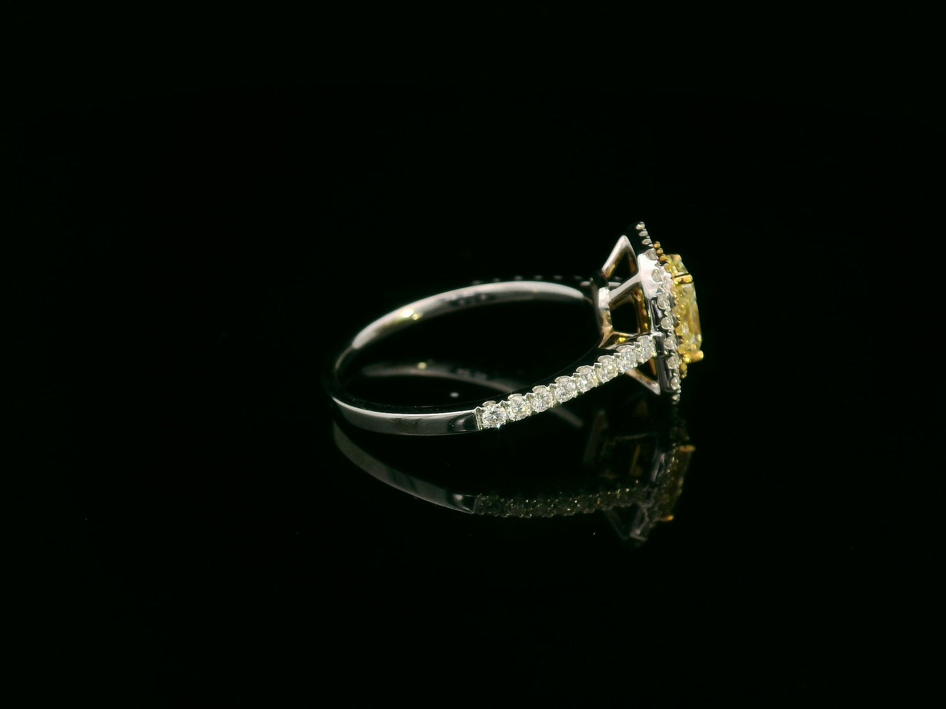 18K white gold fancy yellow radiant-cut diamond ring with yellow inner halo and white diamond outer halo by Emirates Diamonds.