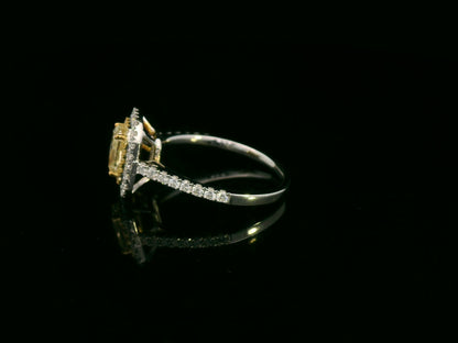 18K white gold fancy yellow radiant-cut diamond ring with yellow inner halo and white diamond outer halo by Emirates Diamonds.