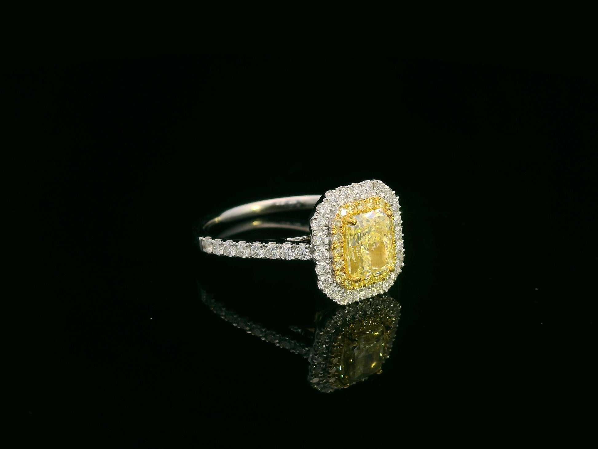 18K white gold fancy yellow radiant-cut diamond ring with yellow inner halo and white diamond outer halo by Emirates Diamonds.