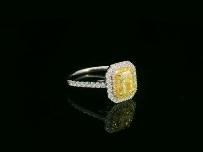 18K white gold fancy yellow radiant-cut diamond ring with yellow inner halo and white diamond outer halo by Emirates Diamonds.
