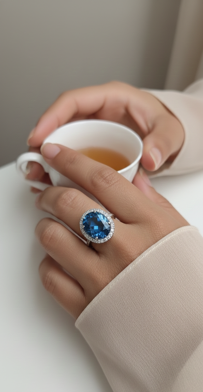 18K white gold ring with 9.15-carat oval London Blue Topaz and double diamond halo – Emirates Diamonds.