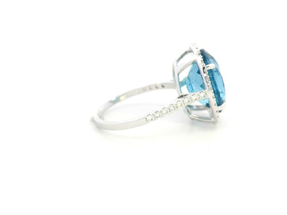 18K white gold ring with 9.15-carat oval London Blue Topaz and double diamond halo – Emirates Diamonds.