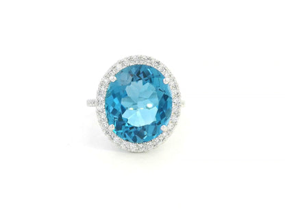18K white gold ring with 9.15-carat oval London Blue Topaz and double diamond halo – Emirates Diamonds.