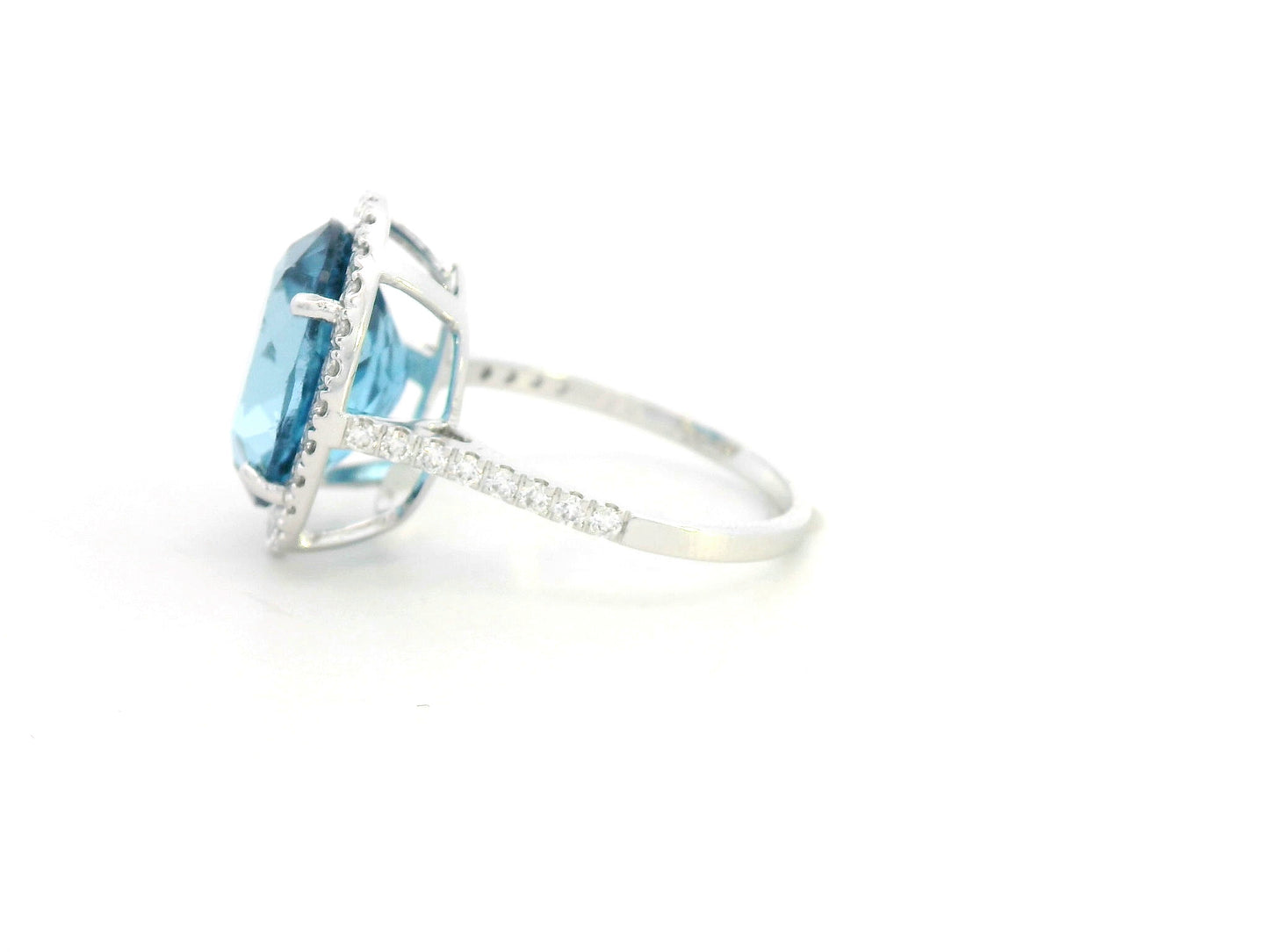 18K white gold ring with 9.15-carat oval London Blue Topaz and double diamond halo – Emirates Diamonds.