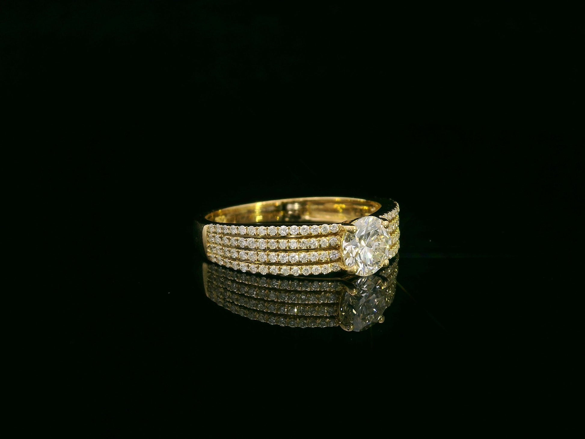 18K yellow gold diamond engagement ring with 0.64 carat center diamond and pavé-set accent diamonds by Emirates Diamonds
