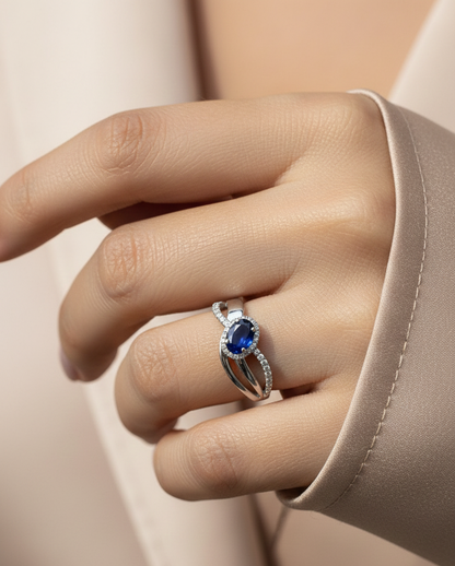 18K white gold blue sapphire and diamond bypass ring with oval sapphire and halo, 0.77 carat sapphire and 0.25 carat total diamond weight, fine jewelry by Emirates Diamonds