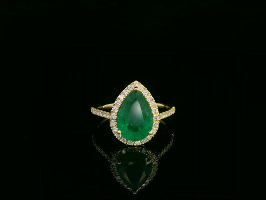 18K yellow gold pear-shaped emerald and diamond halo ring with 2.69 carat emerald and 0.40 carat total diamond weight by Emirates Diamonds