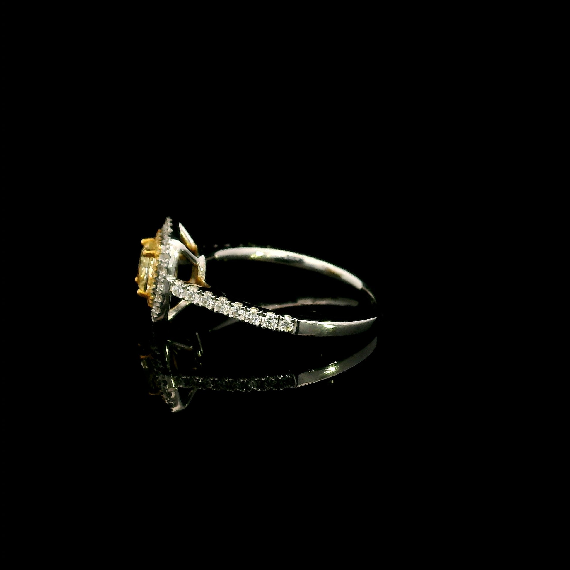 18K white gold engagement ring featuring a 0.58 carat GIA certified Fancy Yellow cushion cut diamond with SI1 clarity, surrounded by yellow and white diamond double halos with a diamond-set band.