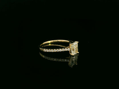 18K yellow gold radiant-cut diamond solitaire ring with pavé diamond band, 0.90 carat IGI certified center diamond and 0.21 carat accent diamonds by Emirates Diamonds