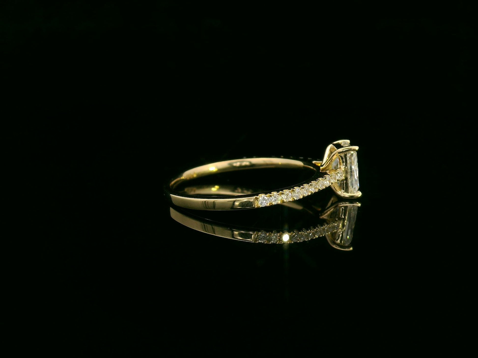 18K yellow gold radiant-cut diamond solitaire ring with pavé diamond band, 0.90 carat IGI certified center diamond and 0.21 carat accent diamonds by Emirates Diamonds