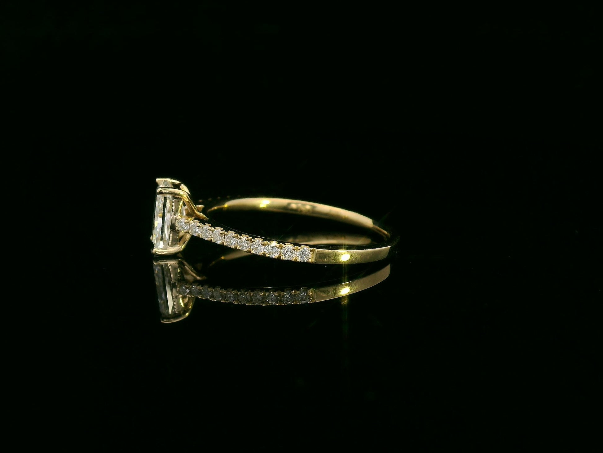 18K yellow gold radiant-cut diamond solitaire ring with pavé diamond band, 0.90 carat IGI certified center diamond and 0.21 carat accent diamonds by Emirates Diamonds