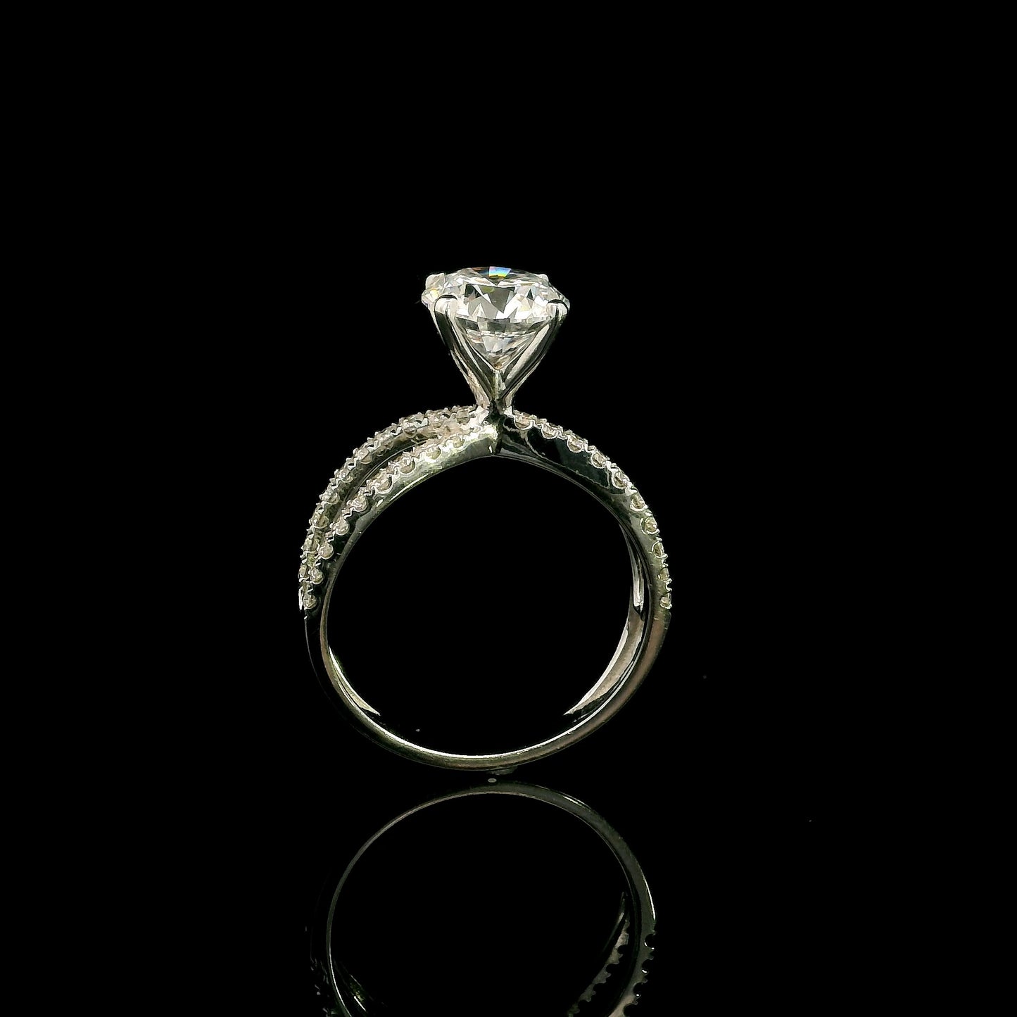18K white gold engagement ring featuring a 2.01 carat GIA certified round brilliant diamond with D color and SI2 clarity in a four-prong setting with a diamond split shank band.