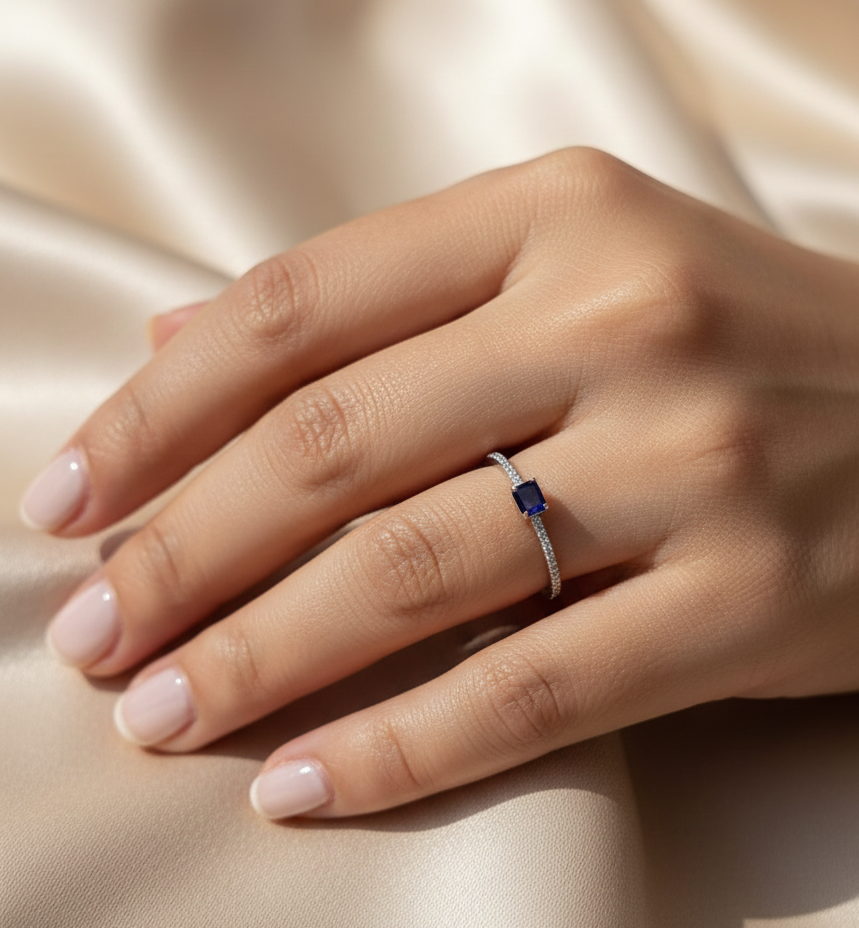 18K white gold blue sapphire solitaire ring with pavé diamond band, 0.25 carat sapphire and 0.08 carat total diamond weight by Emirates Diamonds