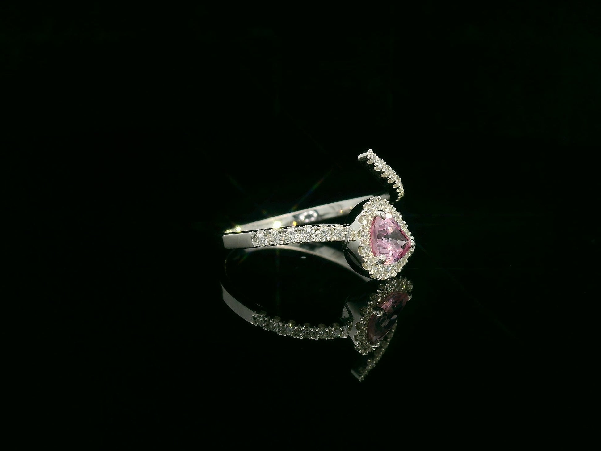 18K white gold pear-shaped pink sapphire and diamond bypass ring with halo design by Emirates Diamonds