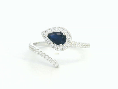 18K white gold bypass ring with pear-shaped blue sapphire and diamond halo by Emirates Diamonds