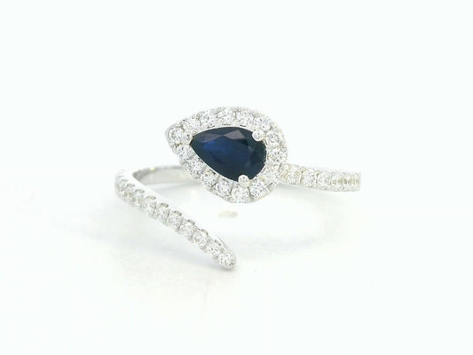 18K white gold bypass ring with pear-shaped blue sapphire and diamond halo by Emirates Diamonds