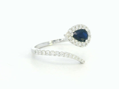 18K white gold bypass ring with pear-shaped blue sapphire and diamond halo by Emirates Diamonds