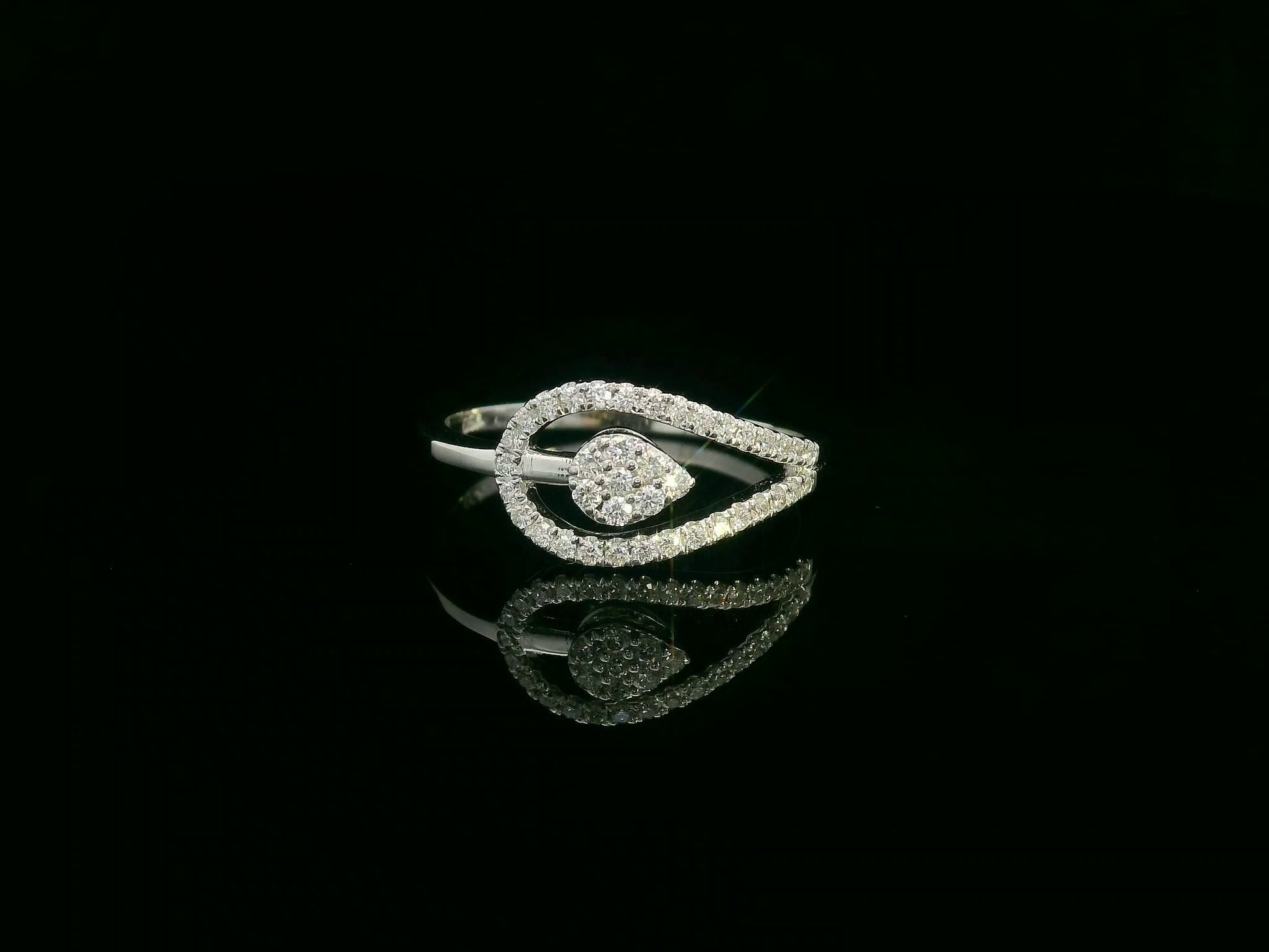 18K white gold diamond bypass ring featuring a teardrop-shaped diamond cluster and pavé set band by Emirates Diamonds