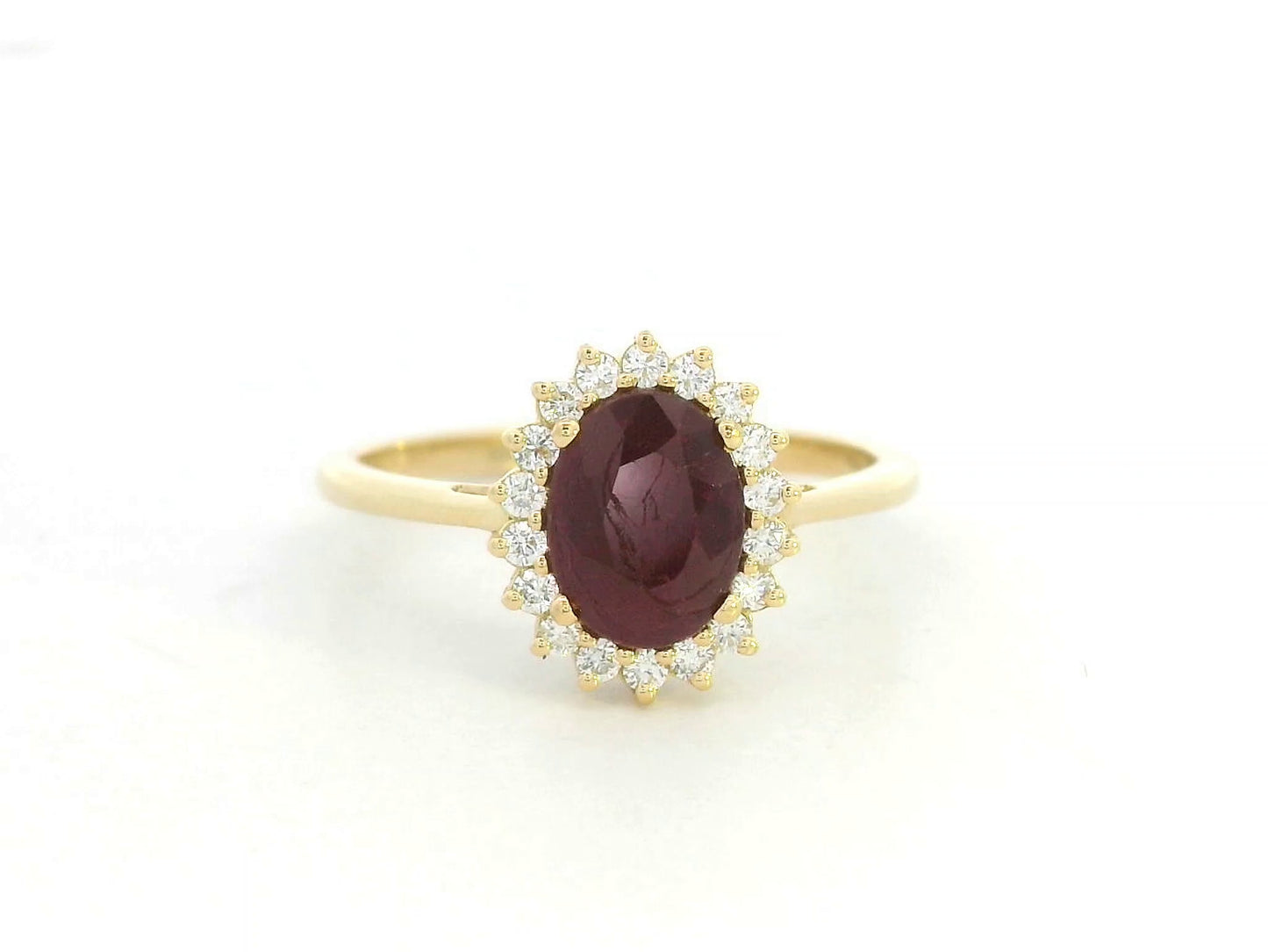 18K yellow gold ruby and diamond halo ring featuring a 1.28 carat oval ruby and 0.19 carat natural diamonds by Emirates Diamonds