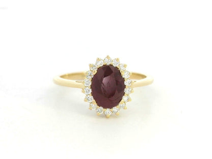 18K yellow gold ruby and diamond halo ring featuring a 1.28 carat oval ruby and 0.19 carat natural diamonds by Emirates Diamonds