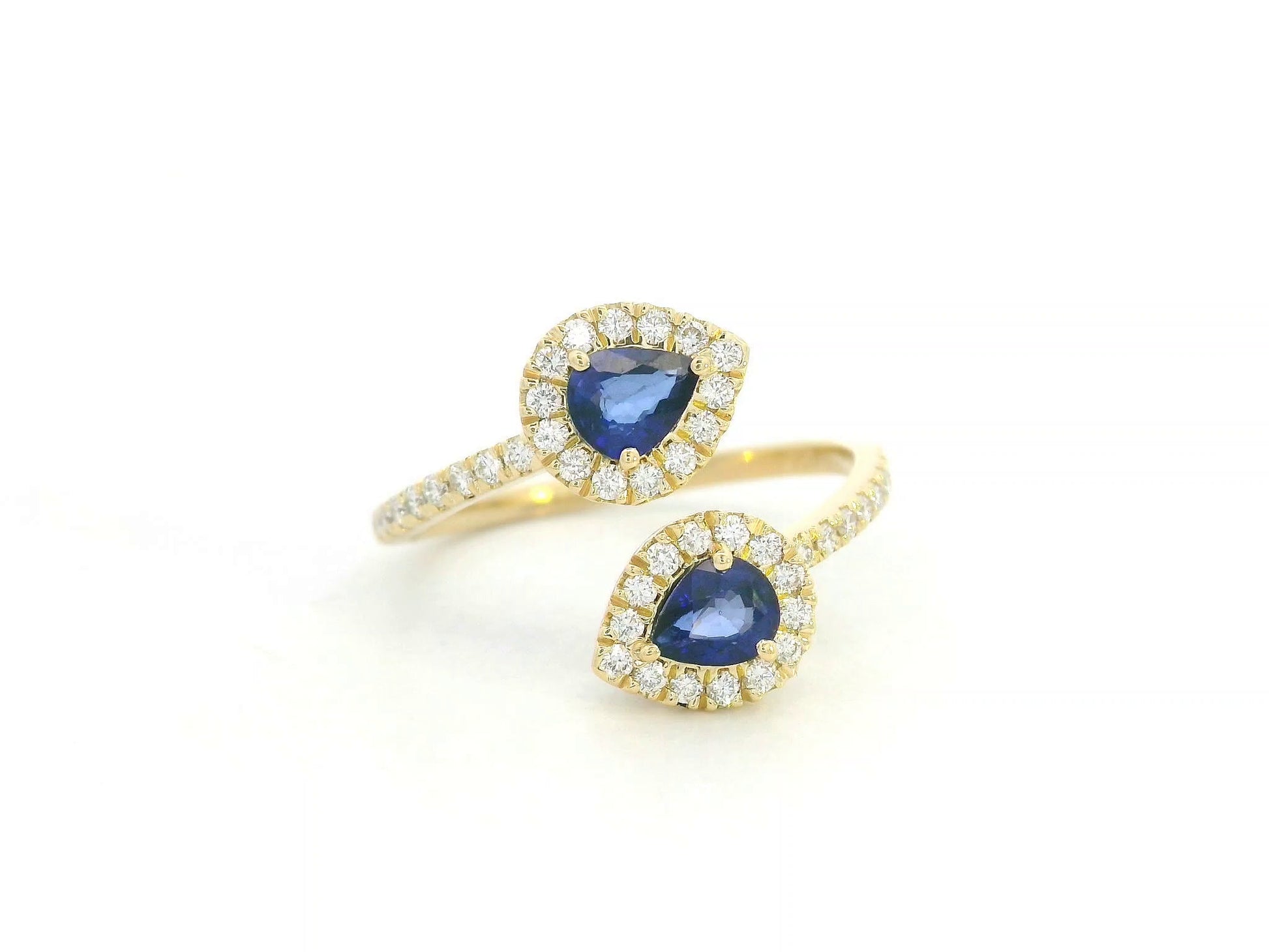 Blue sapphire and diamond Toi-et-Moi ring in 18K yellow gold with pear-shaped sapphires and diamond halo by Emirates Diamonds