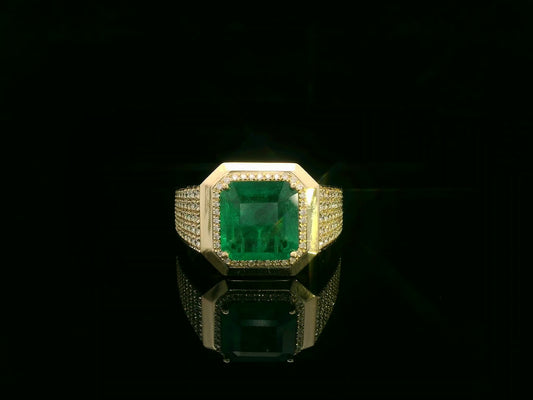Men’s 18K yellow gold emerald and diamond statement ring featuring a 3.30 carat emerald with diamond halo and wide pavé band by Emirates Diamonds