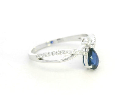 18K white gold blue sapphire and diamond crossover band ring, pear-shaped sapphire with pavé diamond accents by Emirates Diamonds
