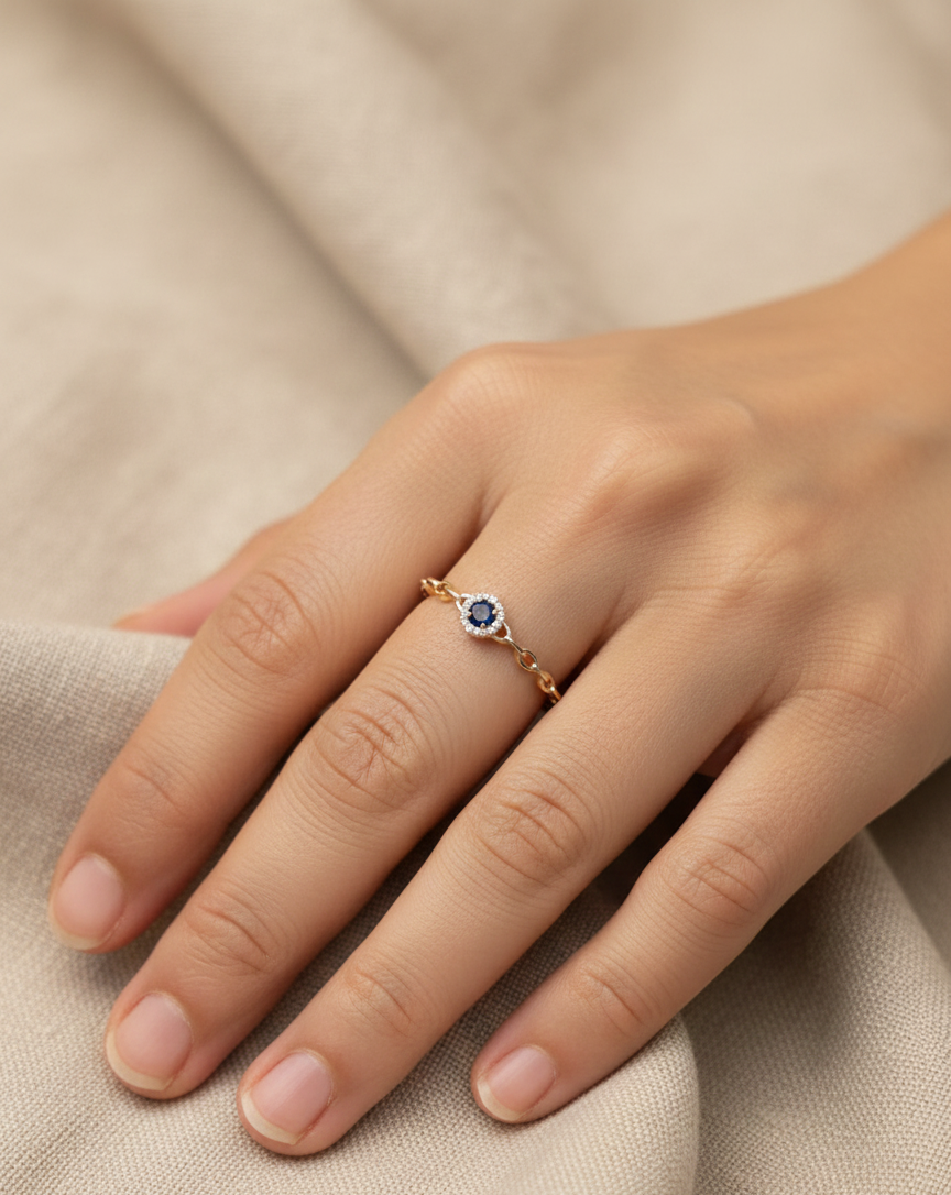 18K yellow gold blue sapphire and diamond halo ring with delicate chain band, 0.21 carat gemstones by Emirates Diamonds