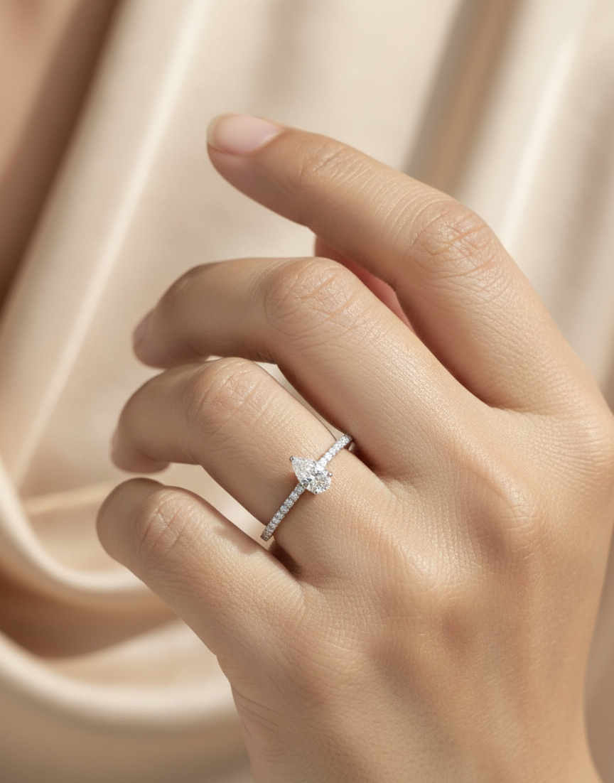 18K white gold pear-shaped diamond ring with pavé band by Emirates Diamonds