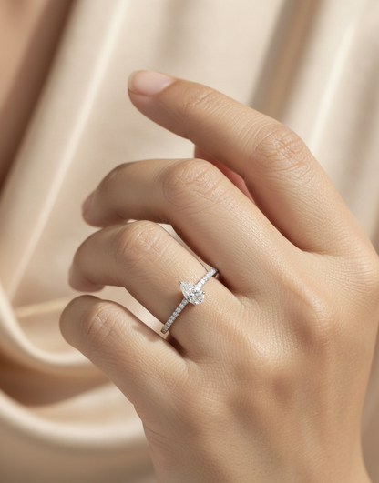 18K white gold pear-shaped diamond ring with pavé band by Emirates Diamonds