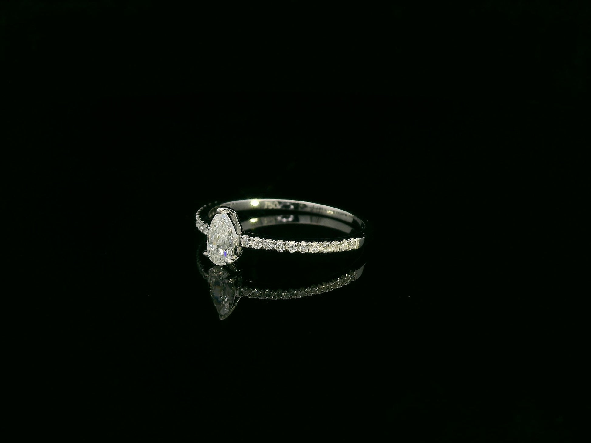 18K white gold pear-shaped diamond ring with pavé band by Emirates Diamonds