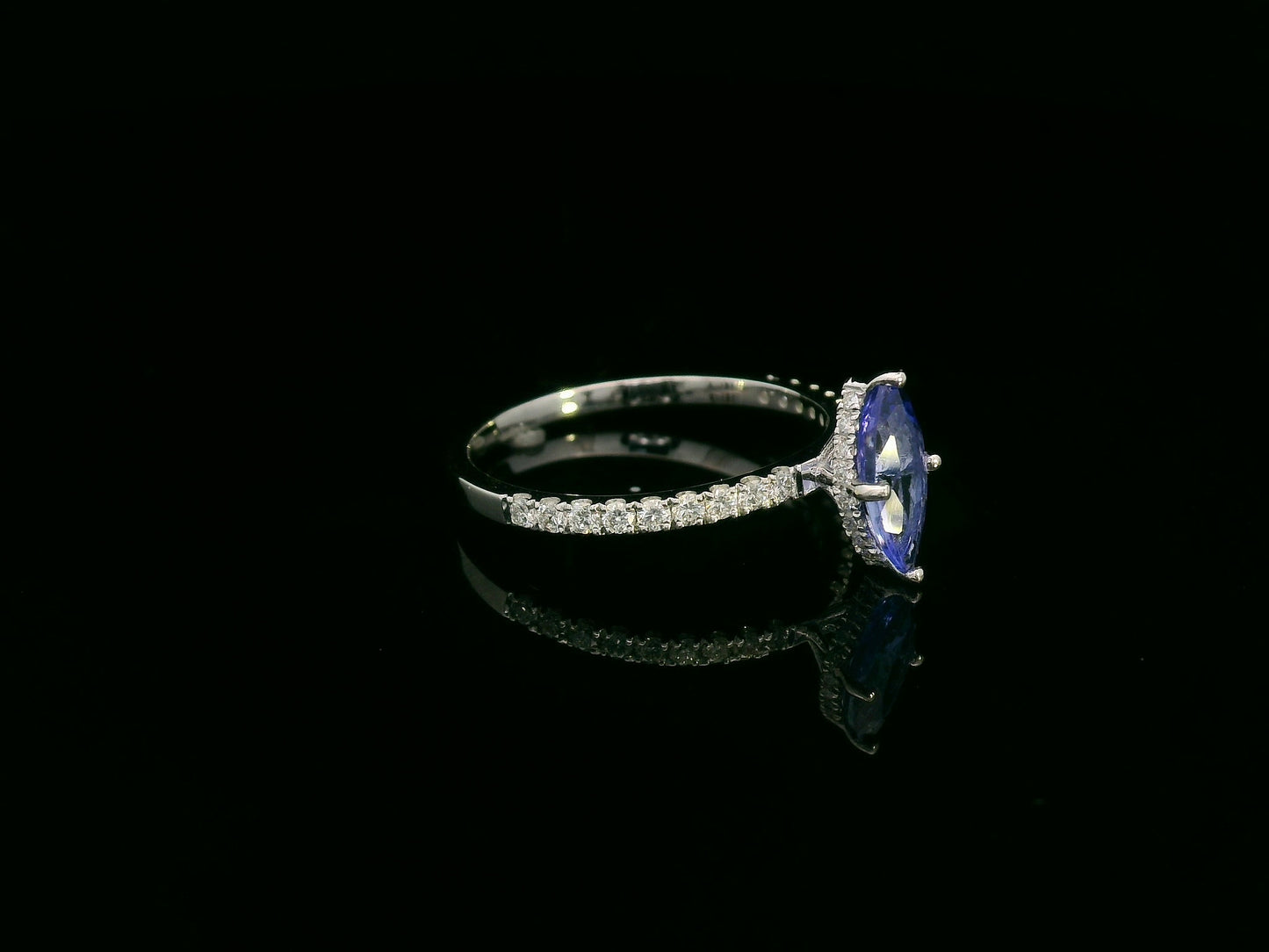 18K white gold marquise-cut tanzanite ring with diamond halo and pavé band by Emirates Diamonds