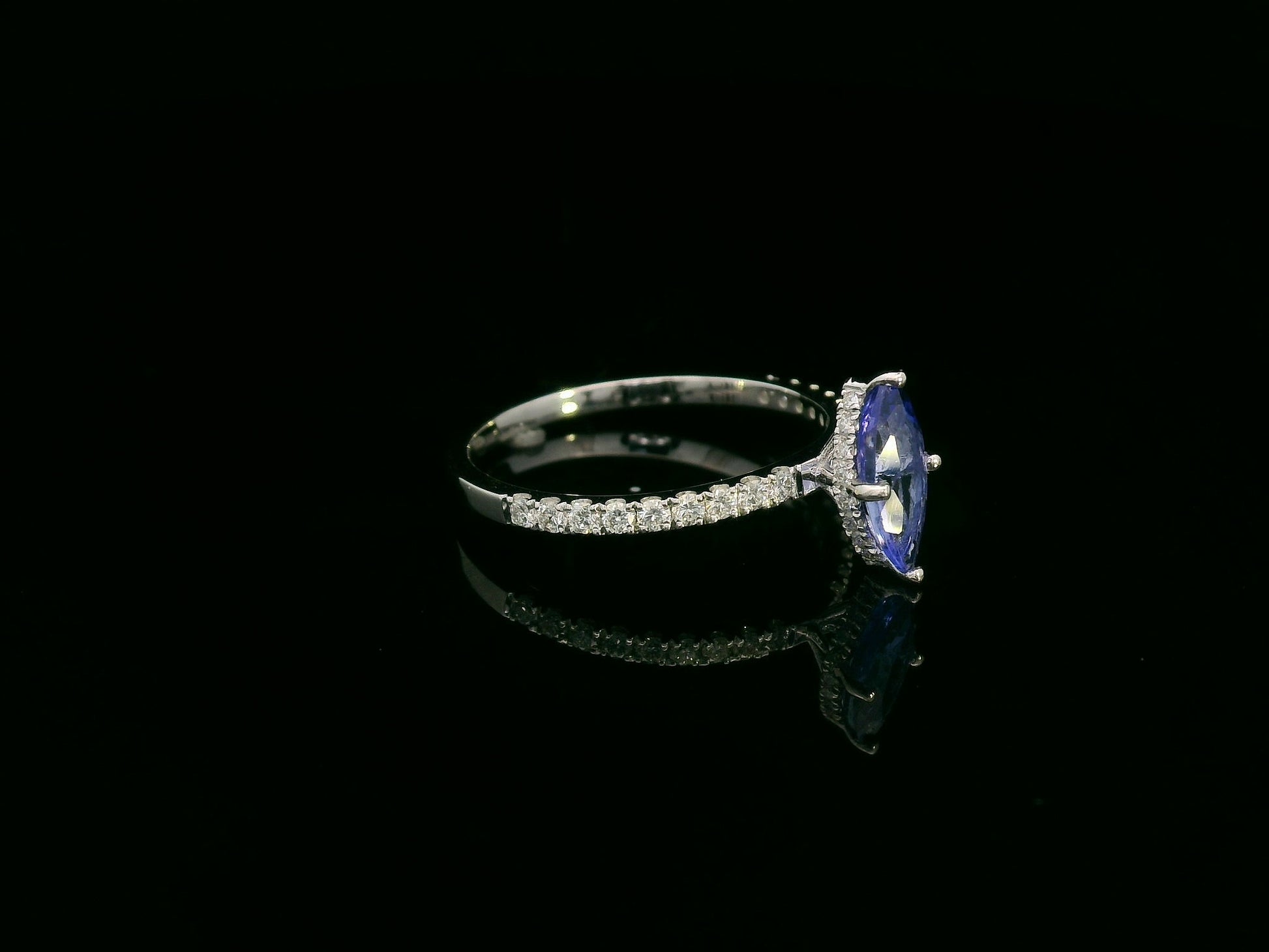 18K white gold marquise-cut tanzanite ring with diamond halo and pavé band by Emirates Diamonds