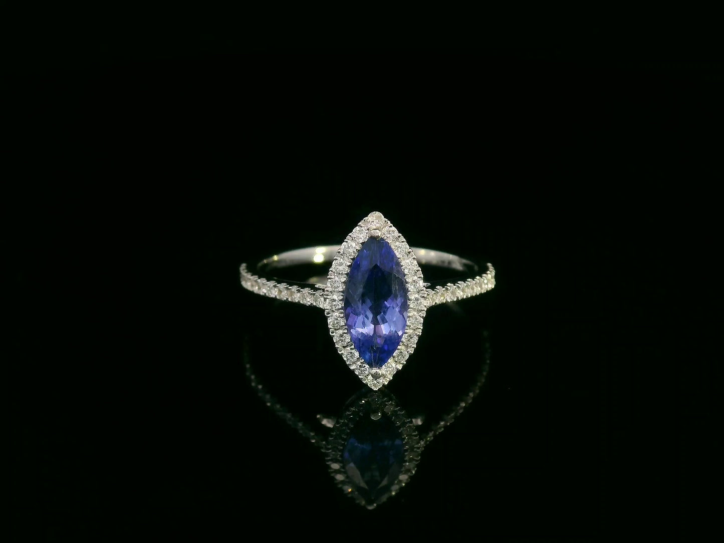 18K white gold marquise-cut tanzanite ring with diamond halo and pavé band by Emirates Diamonds