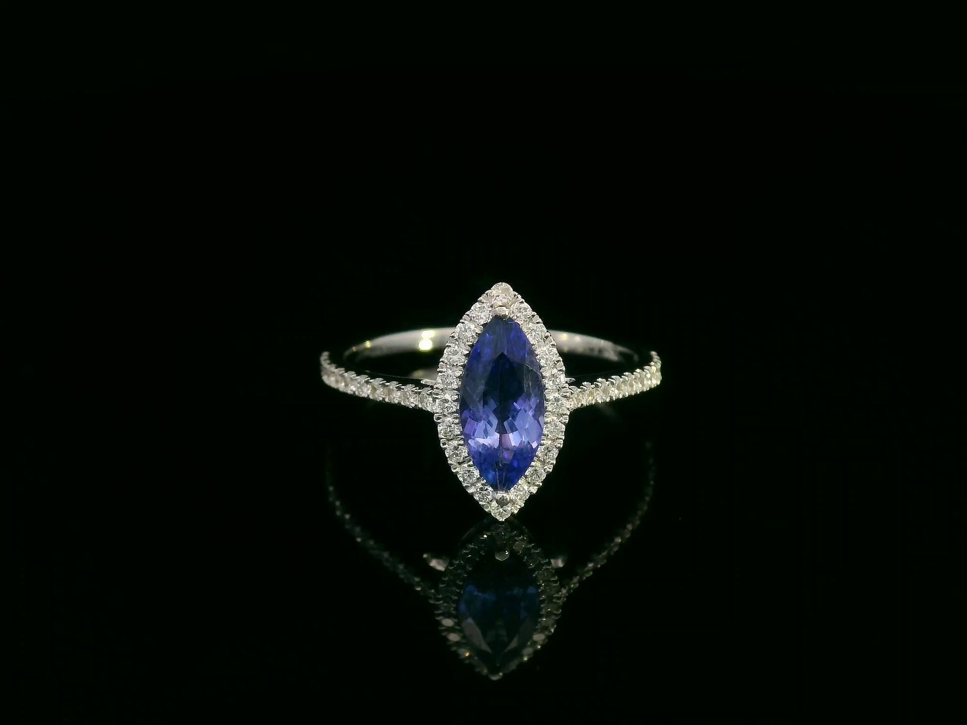 18K white gold marquise-cut tanzanite ring with diamond halo and pavé band by Emirates Diamonds