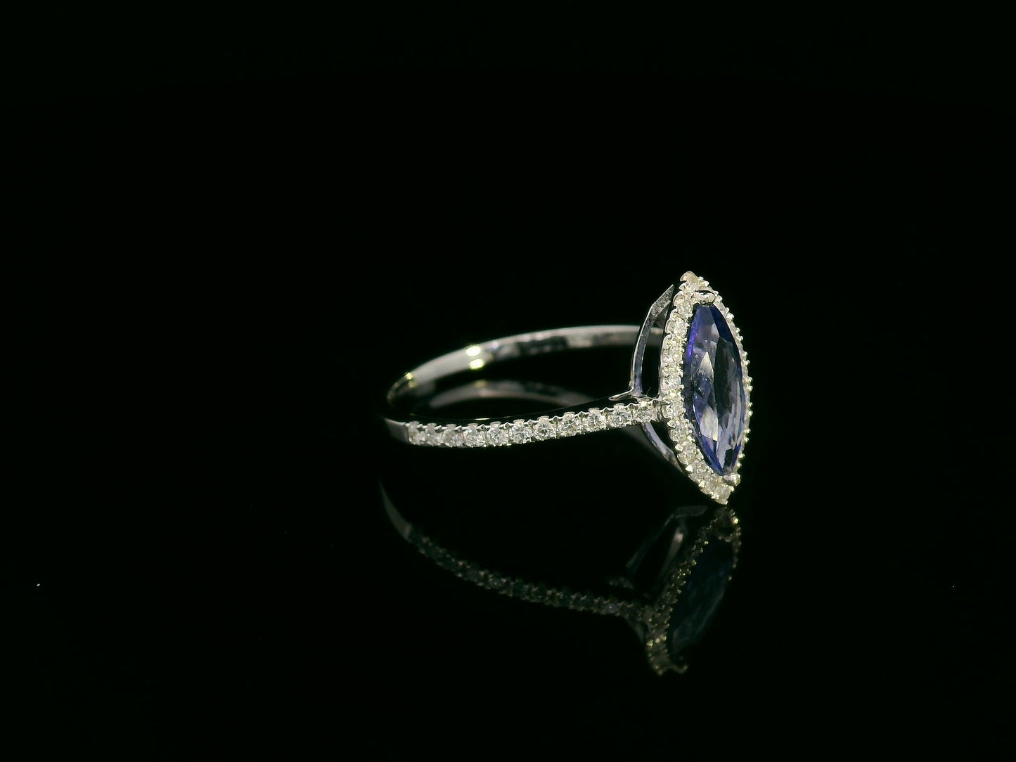 18K white gold marquise-cut tanzanite ring with diamond halo and pavé band by Emirates Diamonds