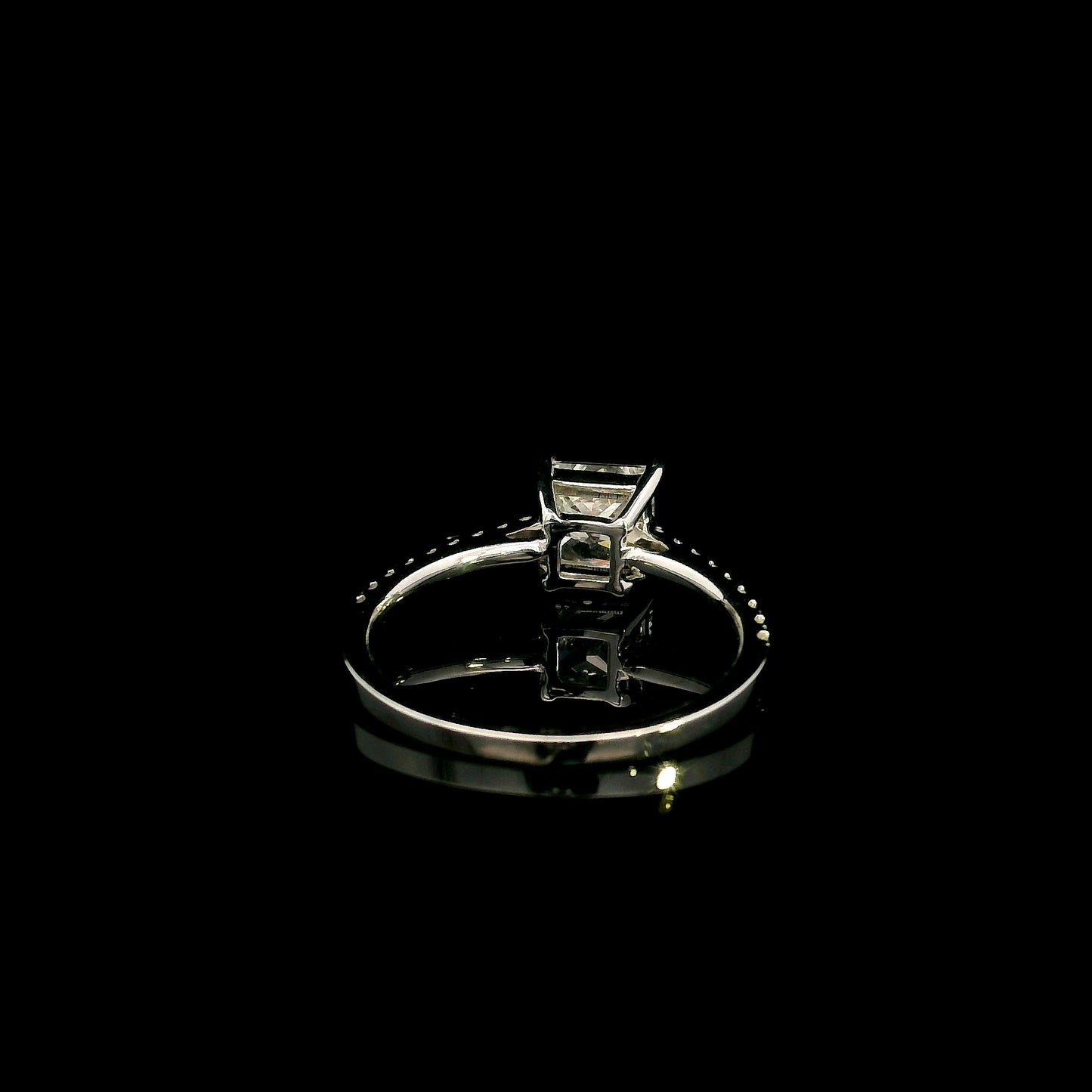 18K white gold engagement ring featuring a 1.50 carat IGI certified natural princess cut diamond with G color and SI2 clarity, accented by 0.20 carat natural round brilliant diamonds on the band.