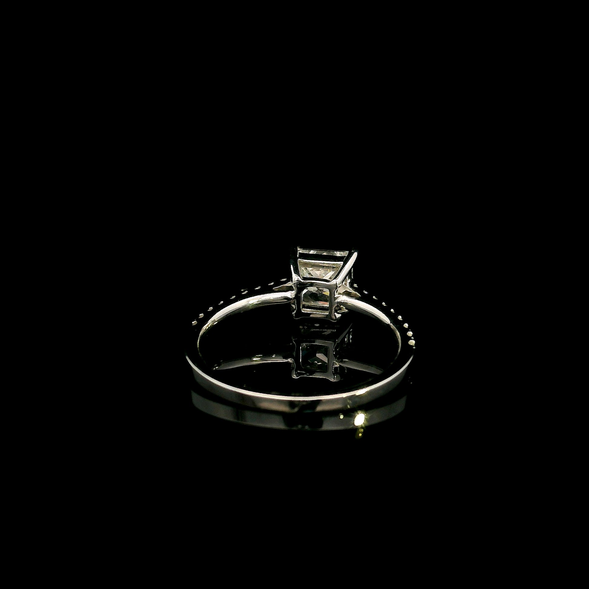 18K white gold engagement ring featuring a 1.50 carat IGI certified natural princess cut diamond with G color and SI2 clarity, accented by 0.20 carat natural round brilliant diamonds on the band.