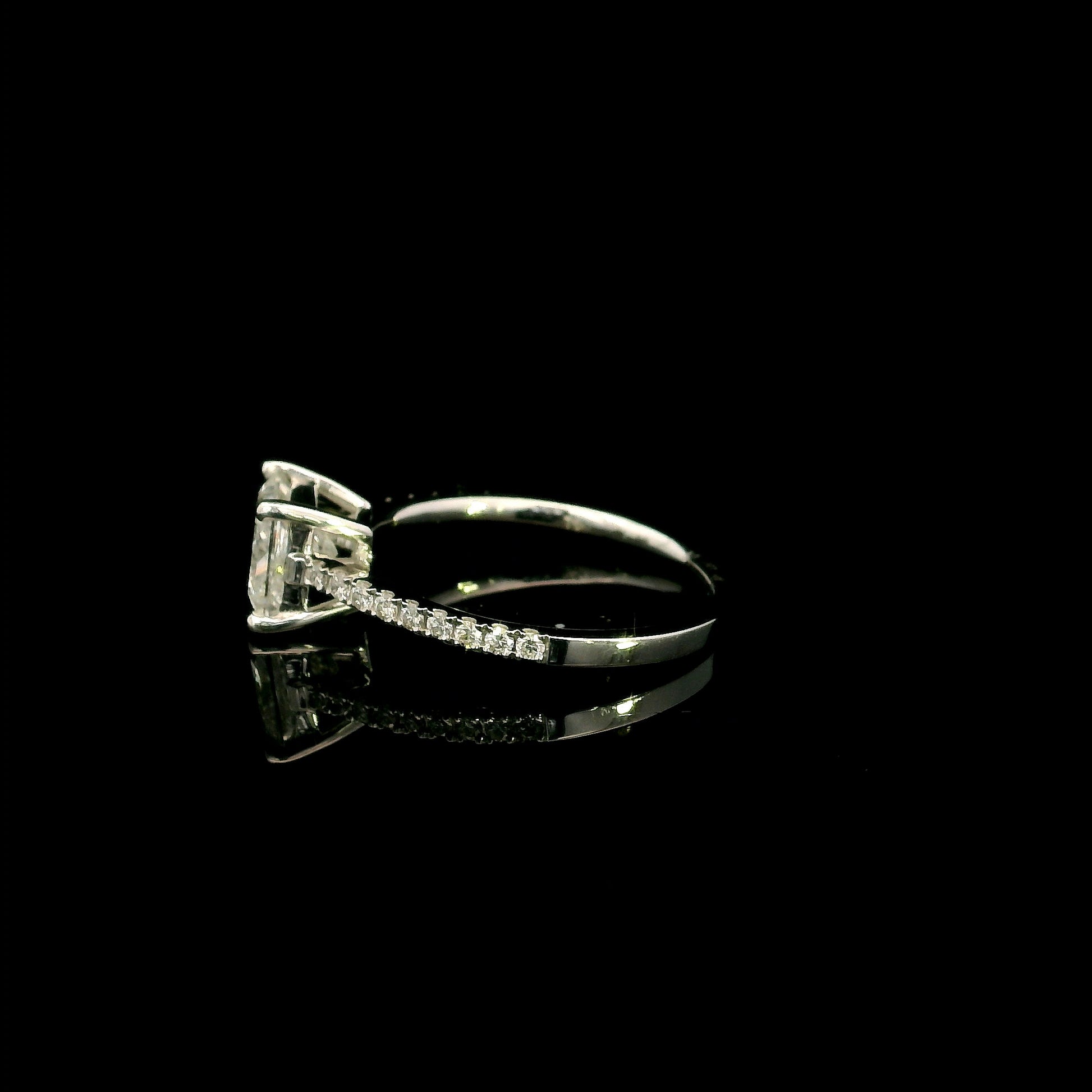 18K white gold engagement ring featuring a 1.50 carat IGI certified natural princess cut diamond with G color and SI2 clarity, accented by 0.20 carat natural round brilliant diamonds on the band.